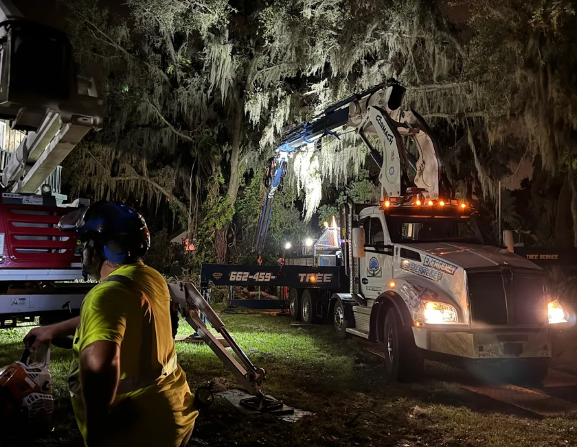 Night emergency crane operation with crew running saws under lights