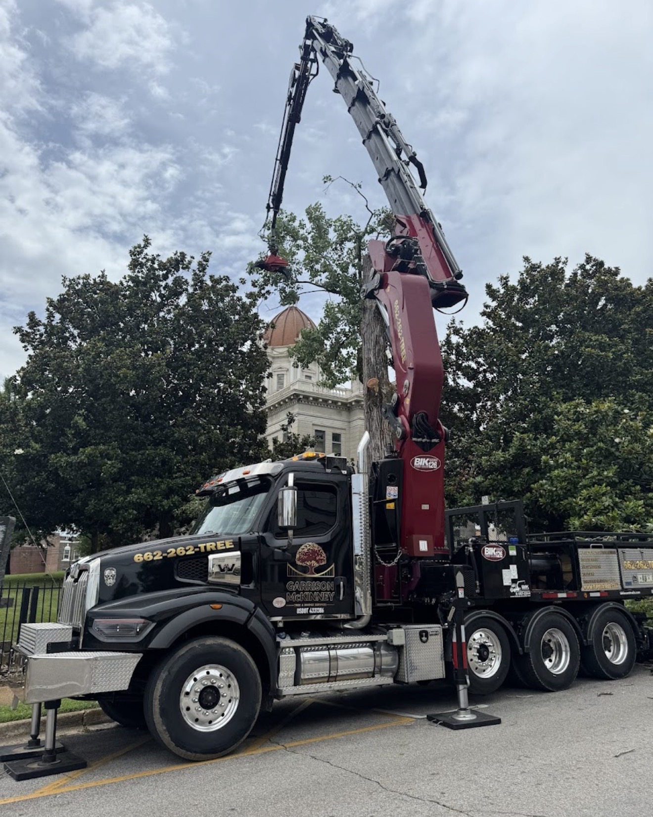 Garrison McKinney knuckleboom crane truck working downtown Corinth, MS